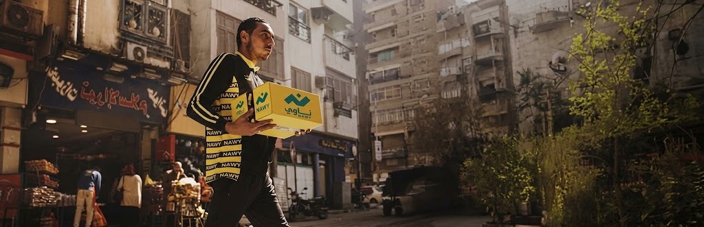 A Nawy delivery agent carrying a box